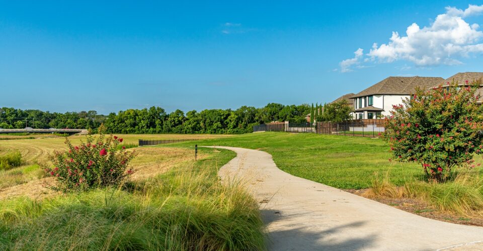 Auburn Hills trail concrete path with landscaping and green grass