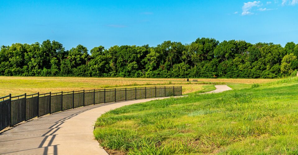 Auburn Hills trail concrete path with landscaping and green grass