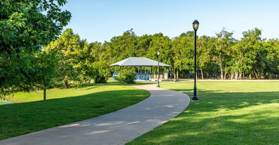 Bonnie Wenk outer loop trail with trees and forestry surrounding it, along with a view of the fitness court in the background.