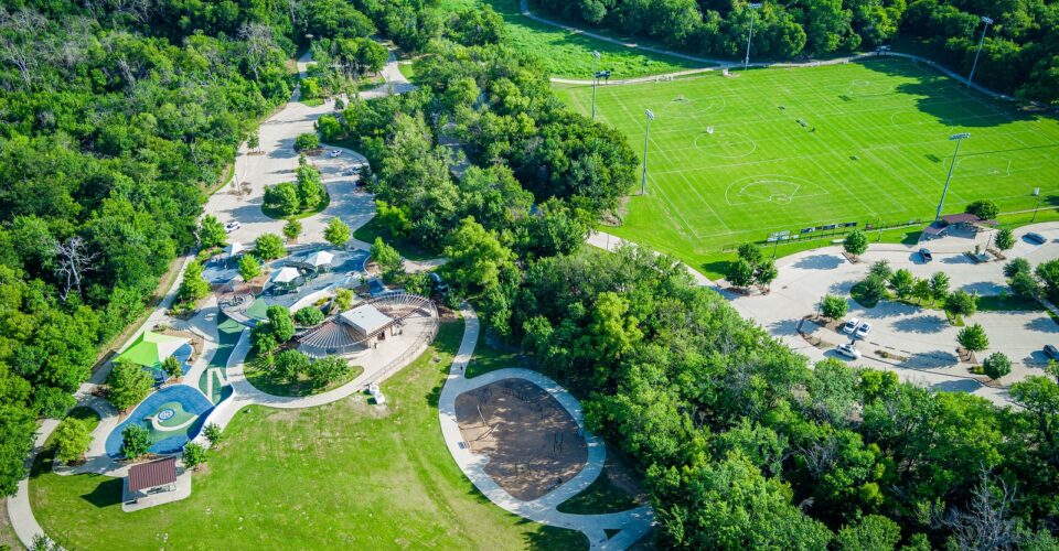Bonnie Wenk outer loop trail aerial with a view of the playgrounds and trail, with trees and forestry surrounding it