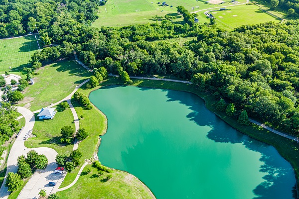 Bonnie Wenk outer loop trail aerial with a view of the park pond and trail, with trees and forestry surrounding it