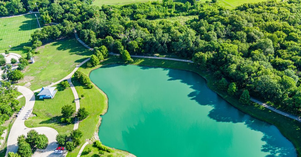 Bonnie Wenk outer loop trail aerial with a view of the park pond and trail, with trees and forestry surrounding it