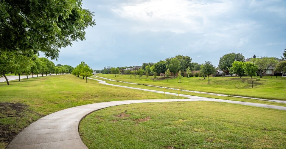 Cottonwood Creek Trail with a shot of the trail winding through grass and nature area