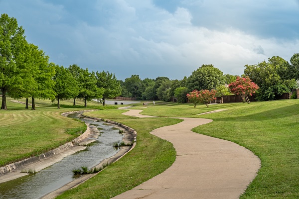 Cottonwood Creek Trail with a shot of the trail winding through grass and nature area, along with a view of the creek