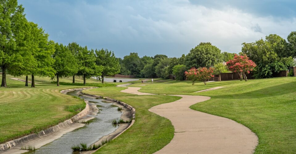 Cottonwood Creek Trail with a shot of the trail winding through grass and nature area, along with a view of the creek