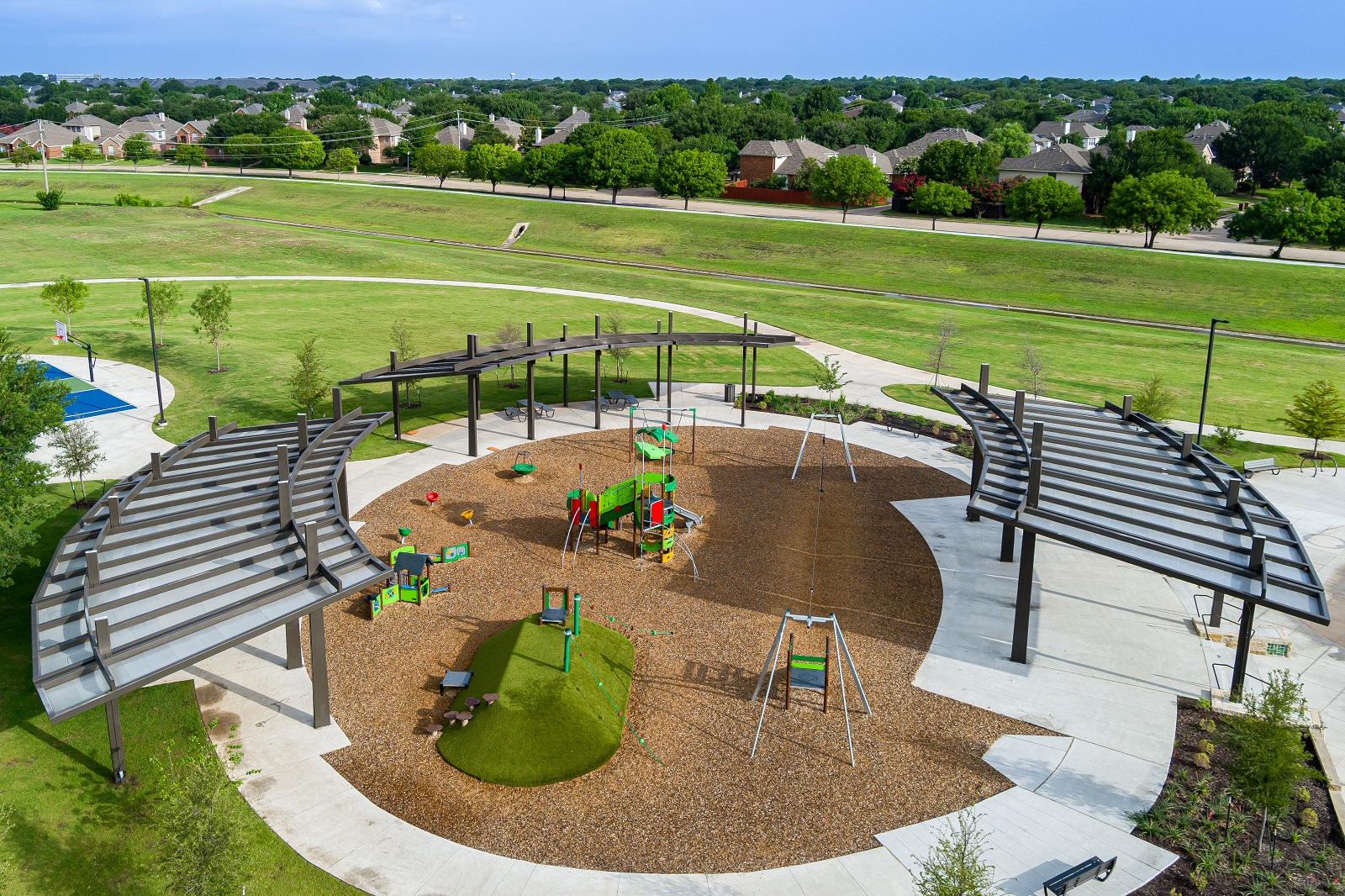 E.A. Randles park aerial of the playground with various play features and an awning.