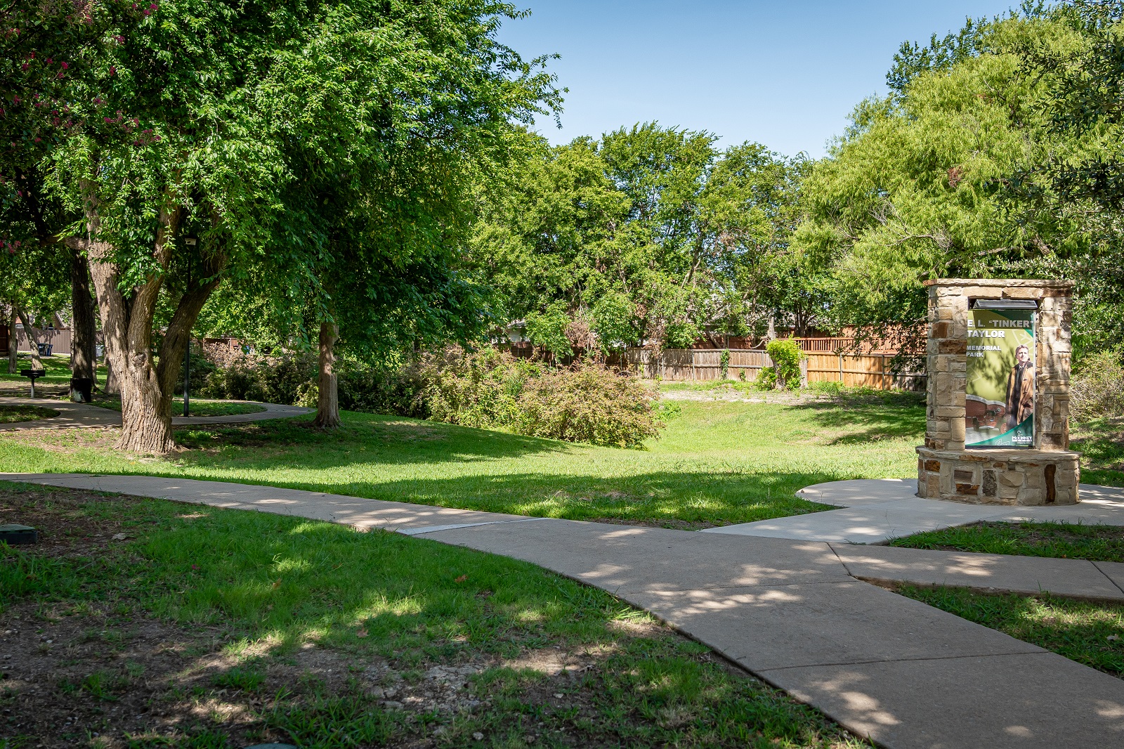 E.L. Tinker Taylor memorial park with green grass, trees, and a walking path