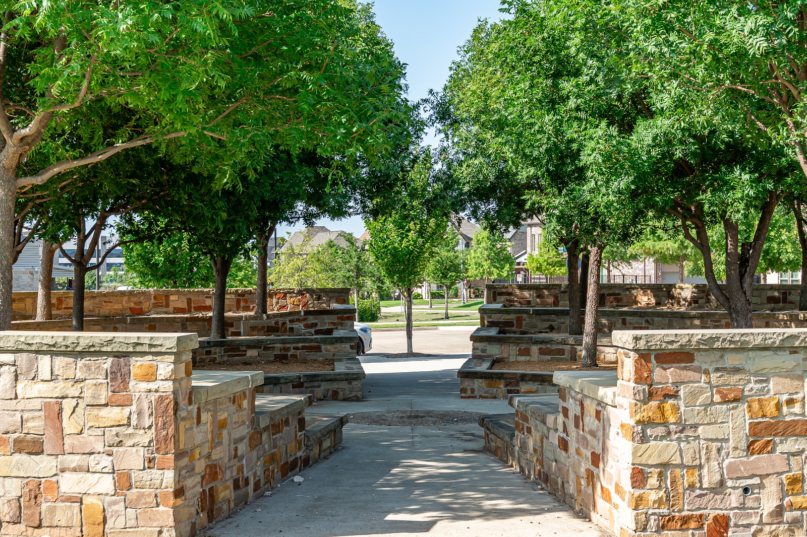 crescent park with circular stone area with seating and steps